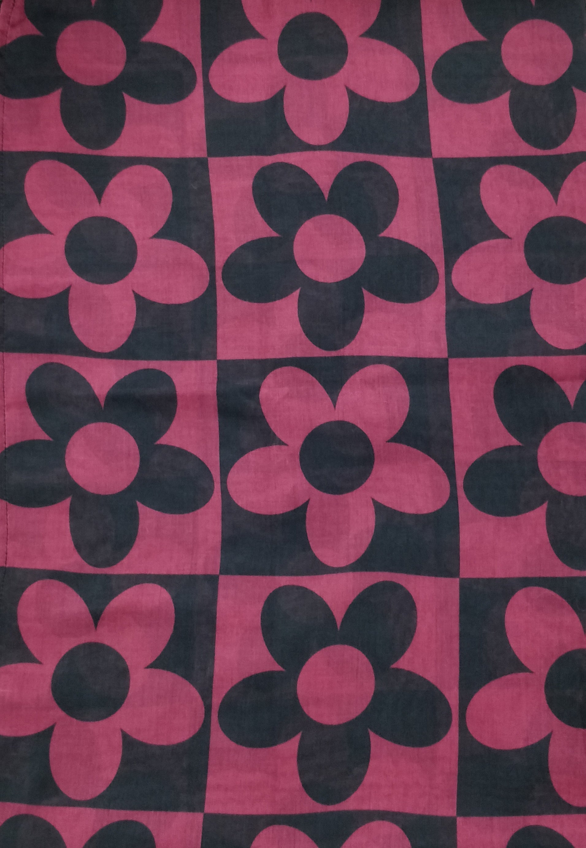 Checkered pattern with pink and black flowers on a black background