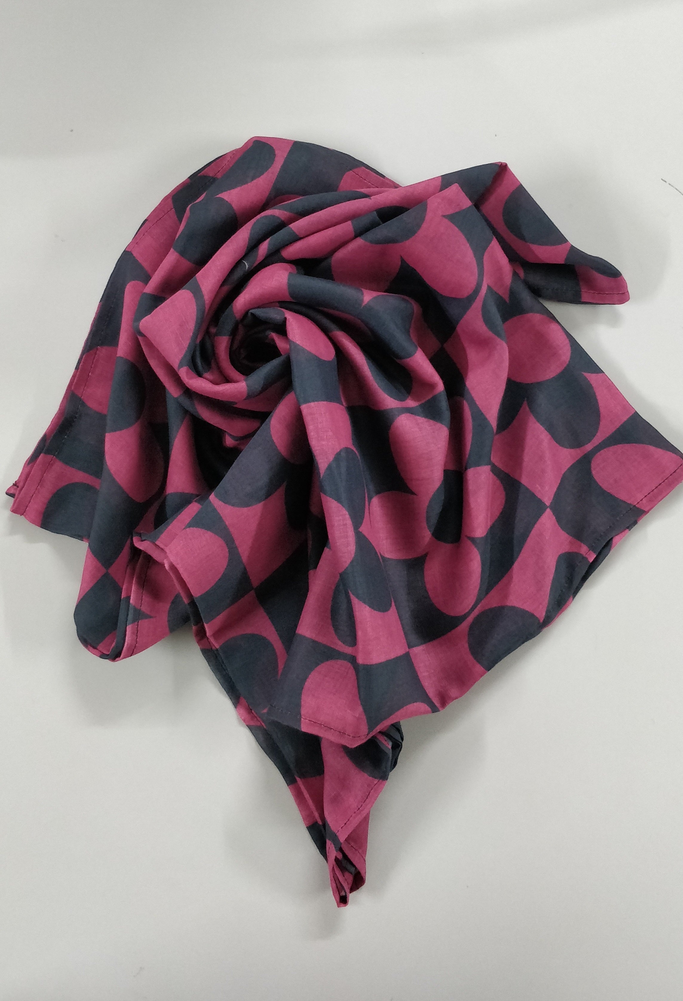 Pink and black patterned Hijab on a white background